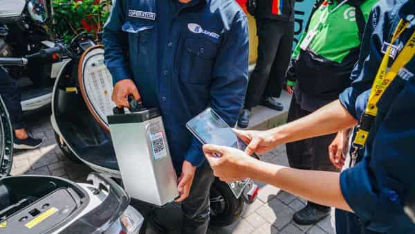 Operators scan a taxi rider